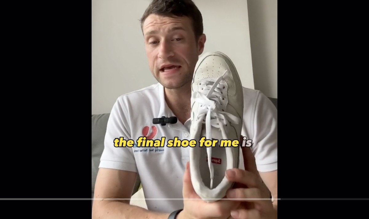 Paul the Podiatrist holding up Nike Air Force 1 sneakers