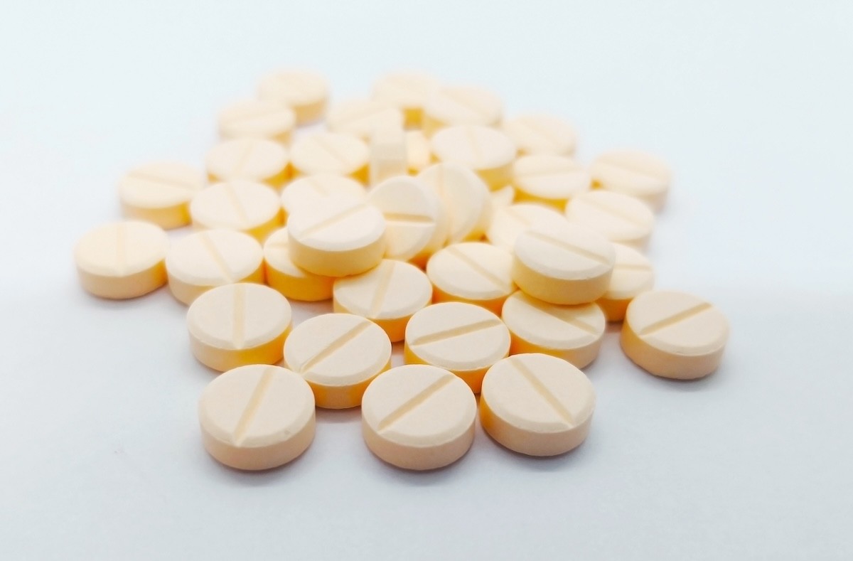 light yellow hydrochlorothiazide pills on a white background
