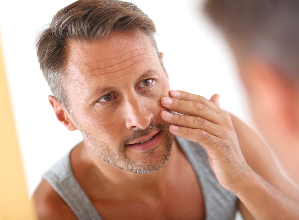 Man Picking at Face Anti-Aging