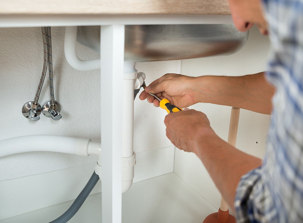man fixing sink small acts of kindness