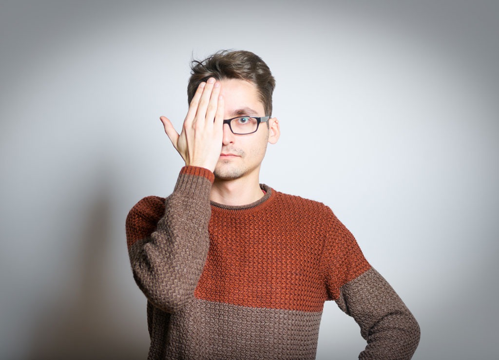 man covering face to demonstrate riddle