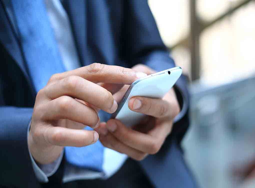 Man Scrolling Through Home Screen on Smartphone